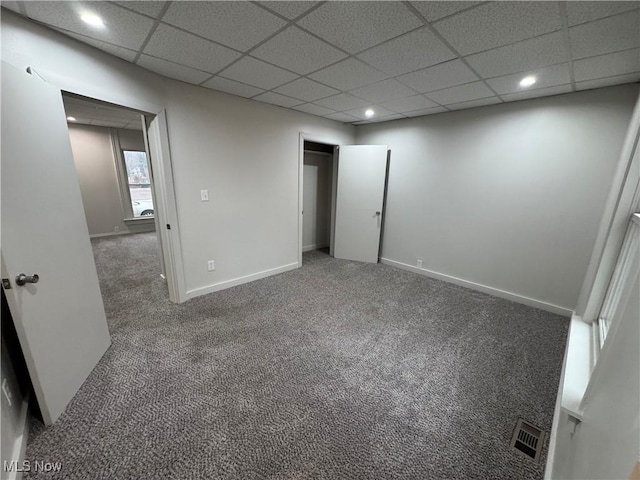 interior space featuring a drop ceiling, recessed lighting, carpet floors, visible vents, and baseboards