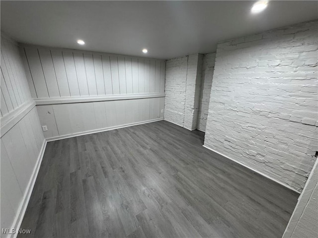 finished basement with dark wood-type flooring, recessed lighting, and baseboards