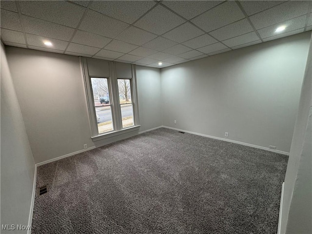 carpeted empty room with a paneled ceiling, visible vents, baseboards, and recessed lighting