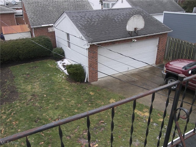 garage with driveway and fence