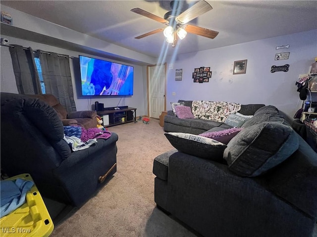 carpeted living area featuring a ceiling fan