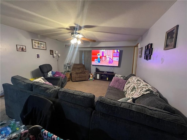 home theater room featuring carpet floors, ceiling fan, and a textured ceiling