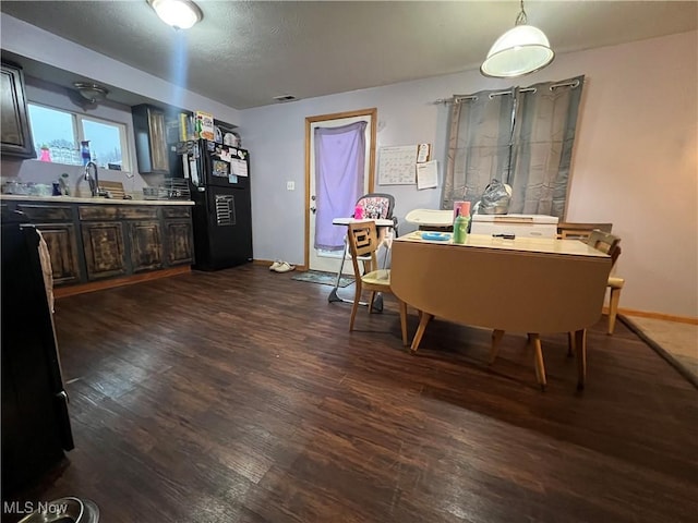 dining room with dark wood-type flooring and baseboards