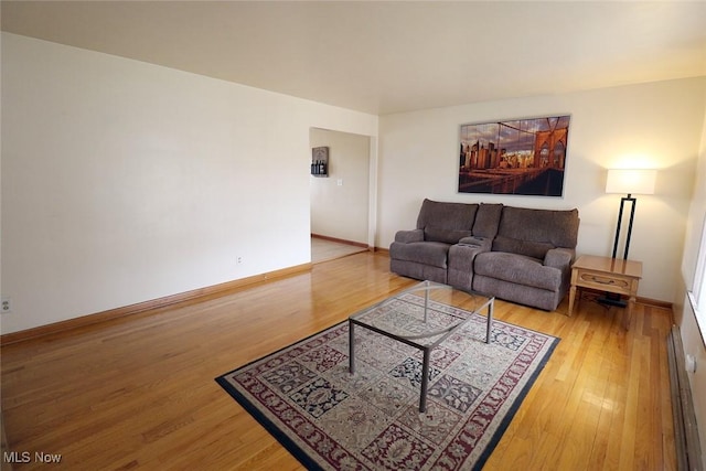 living area featuring wood finished floors and baseboards