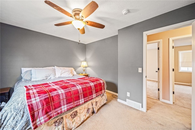 carpeted bedroom featuring a ceiling fan and baseboards