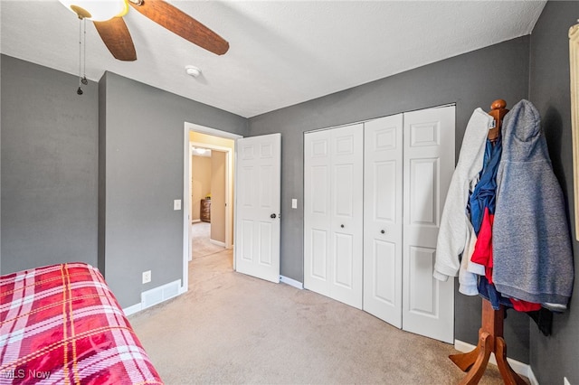 bedroom featuring ceiling fan, carpet floors, visible vents, and baseboards