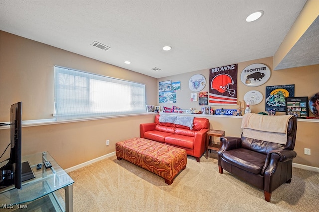 living area with a textured ceiling, recessed lighting, carpet flooring, visible vents, and baseboards