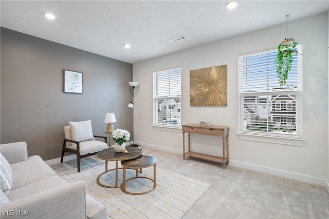 sitting room featuring recessed lighting, baseboards, visible vents, and light colored carpet