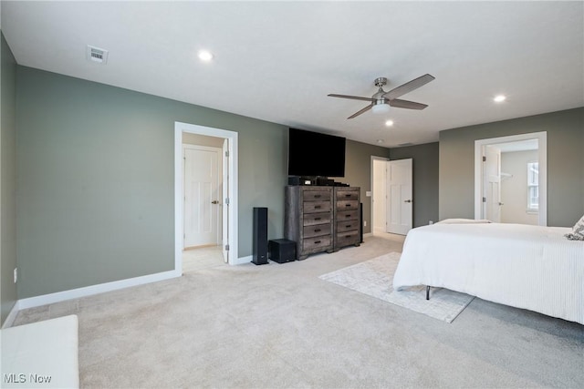 bedroom featuring recessed lighting, light colored carpet, visible vents, ensuite bath, and baseboards