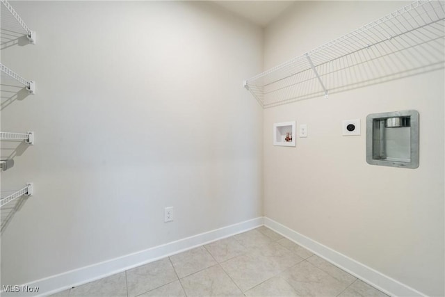 laundry room with light tile patterned floors, hookup for a washing machine, hookup for an electric dryer, laundry area, and baseboards