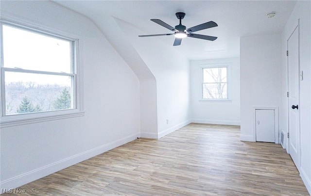 additional living space featuring ceiling fan, baseboards, and wood finished floors