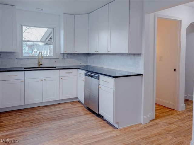 kitchen featuring a sink, dark countertops, light wood-style flooring, and dishwasher