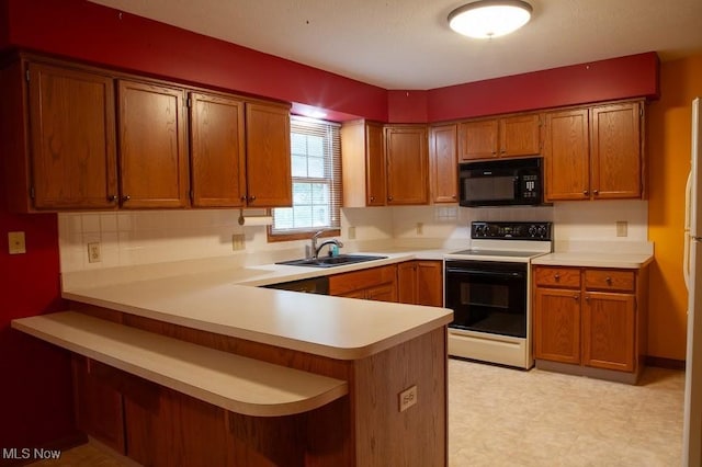 791 Beverly Ave, Canal Fulton, OH 44614 - kitchen with electric range, brown cabinets, a peninsula, black microwave, and a sink