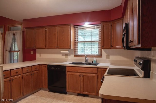 791 Beverly Ave, Canal Fulton, OH 44614 - kitchen with light countertops, a sink, a peninsula, and black appliances