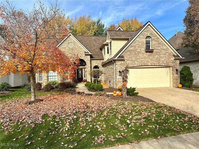 traditional-style home featuring concrete driveway and brick siding