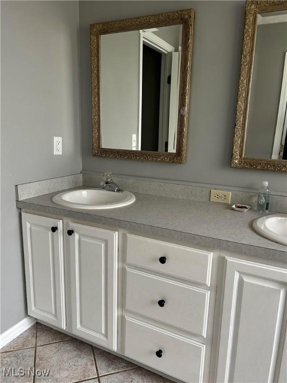 bathroom with tile patterned flooring and vanity