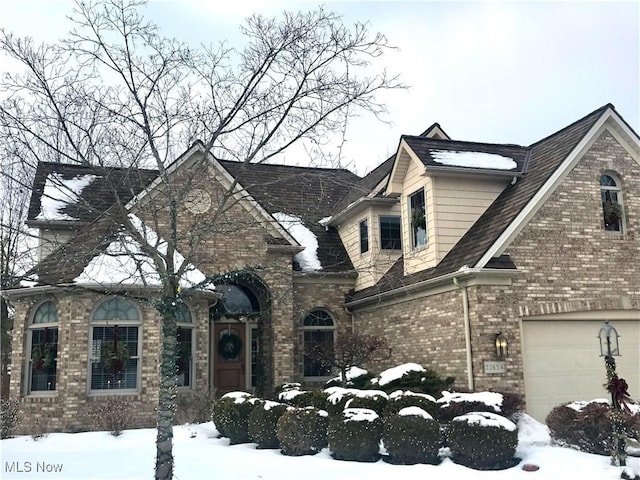 view of front of house featuring a garage and brick siding