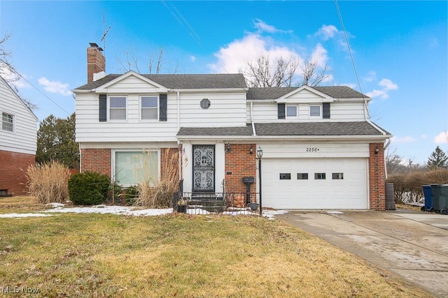 view of front facade featuring brick siding, a chimney, a shingled roof, a front yard, and driveway