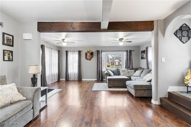 living room with baseboards, dark wood finished floors, and beamed ceiling