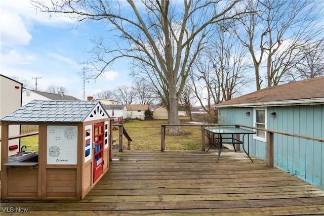 wooden deck featuring fence and a yard