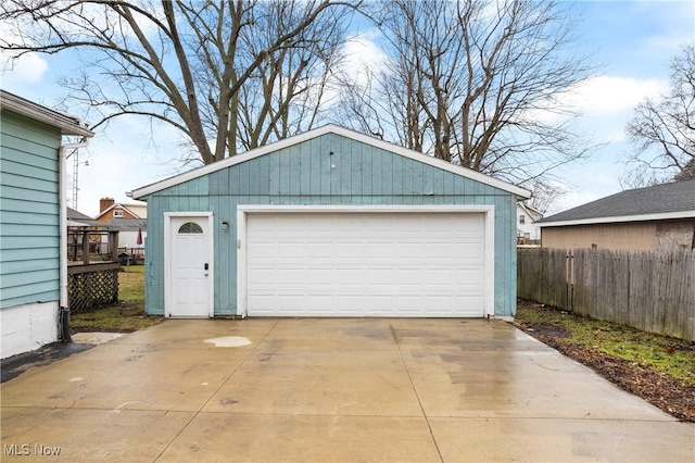 detached garage featuring fence