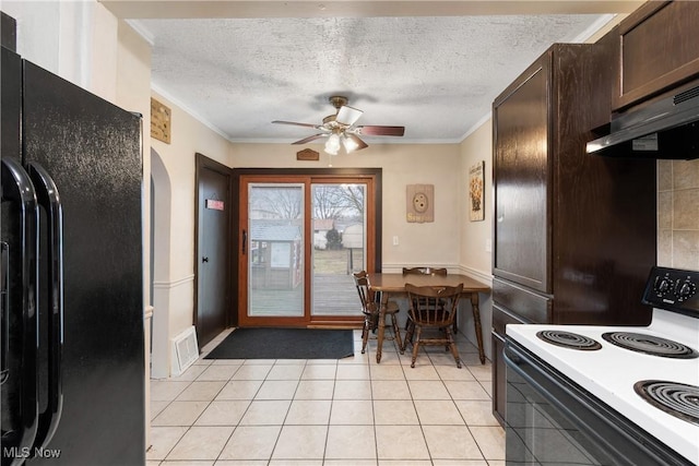 kitchen with a textured ceiling, dark brown cabinetry, under cabinet range hood, range with electric stovetop, and black fridge with ice dispenser