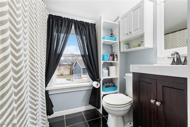 bathroom featuring toilet, tile patterned flooring, baseboards, and vanity