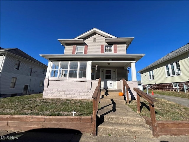 view of front facade featuring covered porch and brick siding