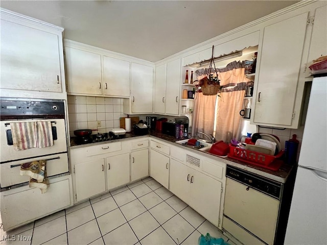 kitchen with white appliances, tasteful backsplash, white cabinetry, and light tile patterned flooring