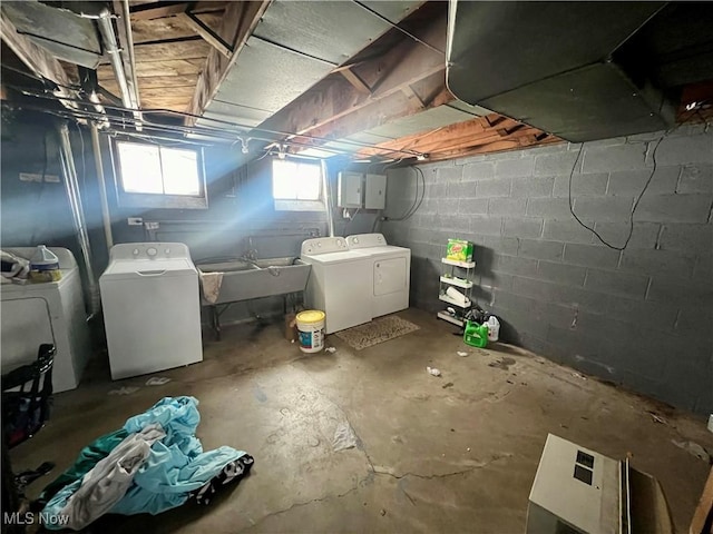 basement with a sink and washer and dryer