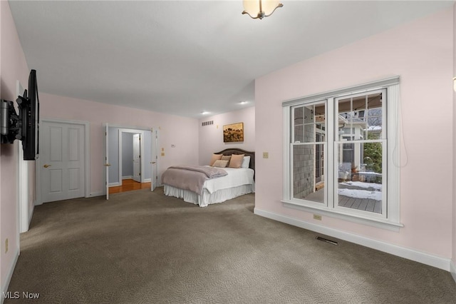 unfurnished bedroom with carpet floors, visible vents, and baseboards