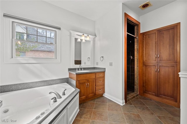 bathroom with baseboards, a garden tub, vanity, and a shower stall