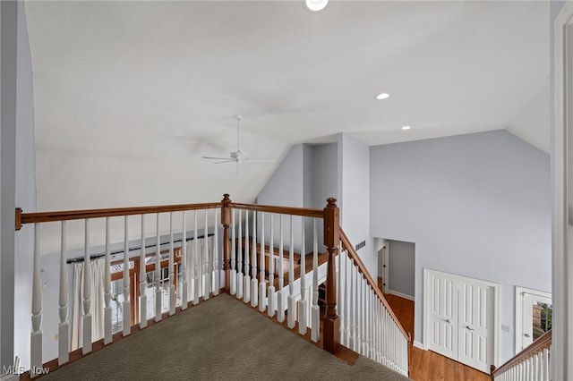 hall featuring lofted ceiling, recessed lighting, and an upstairs landing