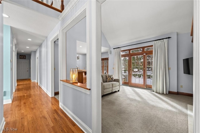 hallway featuring lofted ceiling, carpet floors, recessed lighting, and baseboards