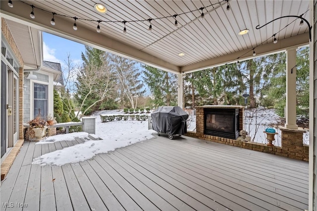 wooden terrace featuring a grill