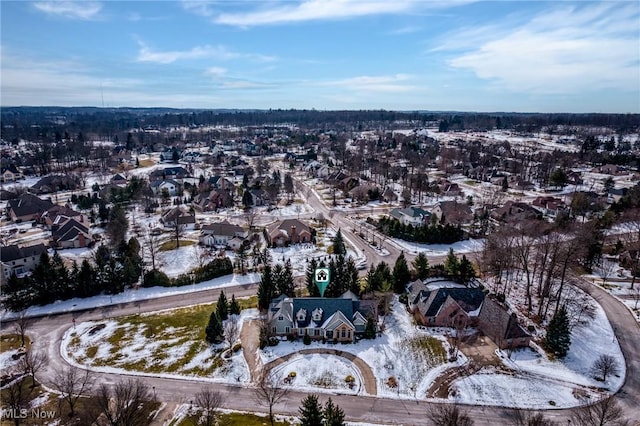 snowy aerial view with a residential view