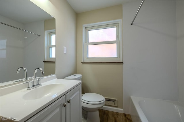 full bath featuring vanity, wood finished floors, toilet, and baseboards