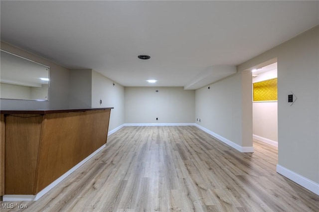 bar with light wood-style floors and baseboards