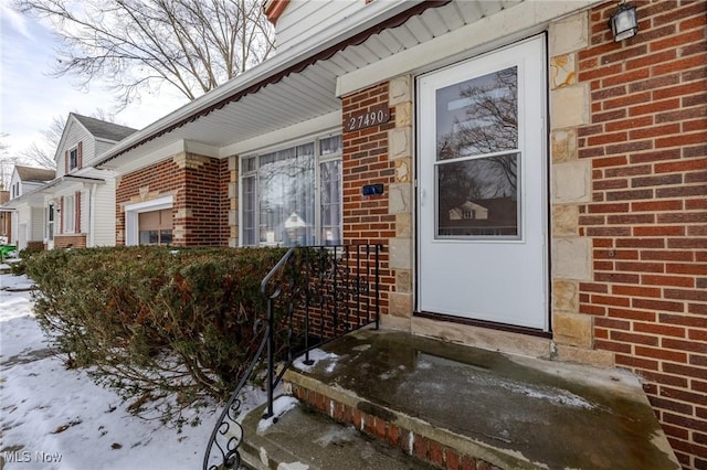 property entrance featuring brick siding