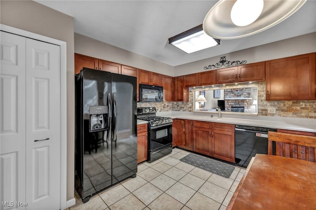 kitchen with black appliances, light tile patterned floors, light countertops, and decorative backsplash