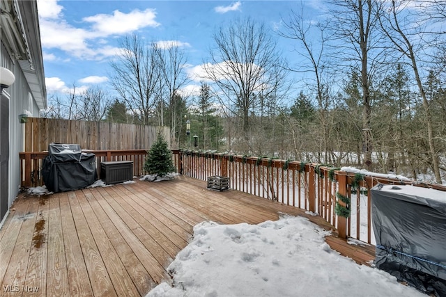 snow covered deck featuring area for grilling