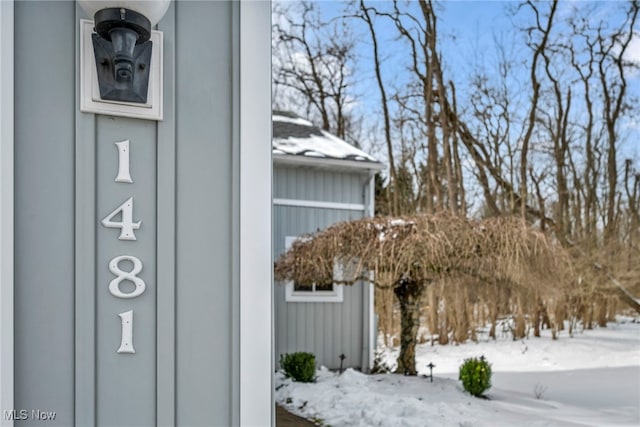 view of snowy exterior with board and batten siding