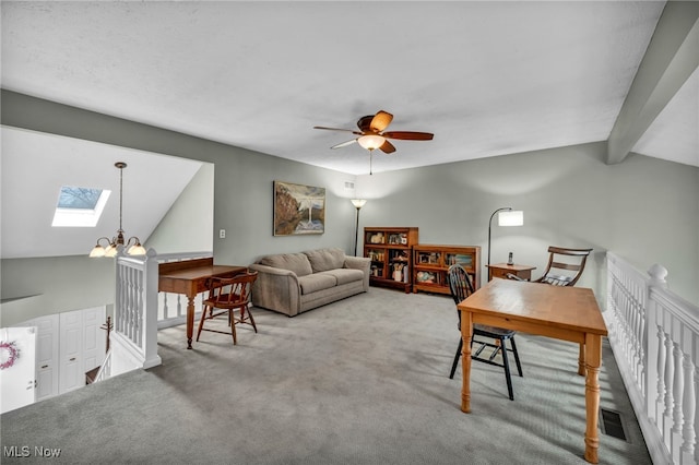 carpeted office with lofted ceiling with skylight, visible vents, and ceiling fan with notable chandelier