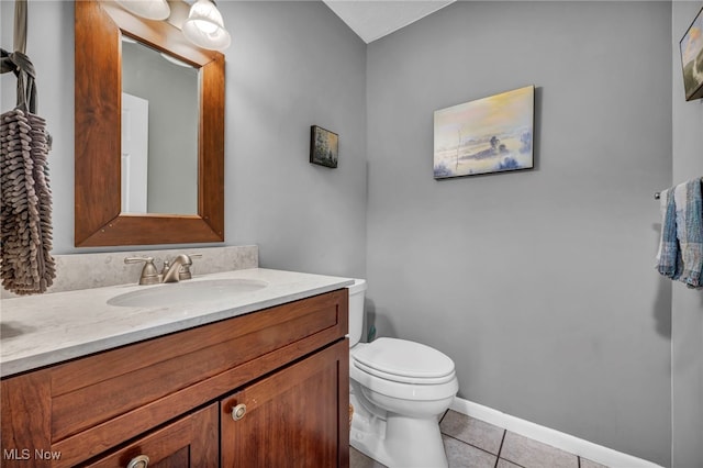 bathroom with baseboards, vanity, toilet, and tile patterned floors