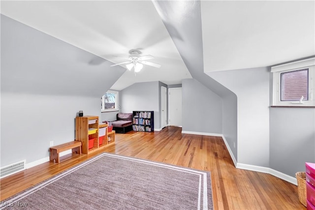 bonus room with visible vents, baseboards, ceiling fan, wood-type flooring, and vaulted ceiling