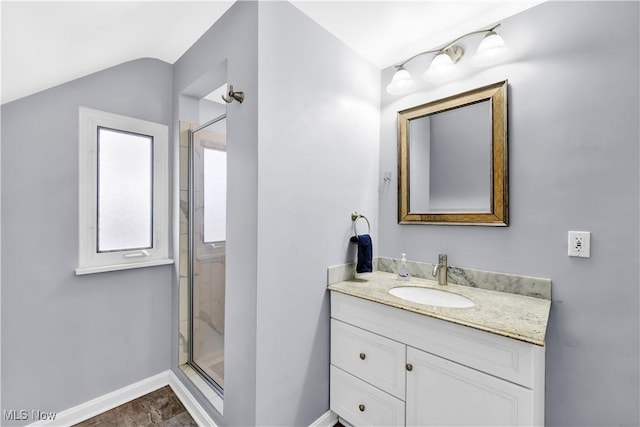 bathroom featuring lofted ceiling, baseboards, a shower stall, and vanity