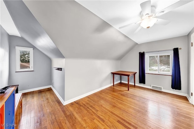 bonus room featuring lofted ceiling, a ceiling fan, baseboards, visible vents, and light wood-style floors