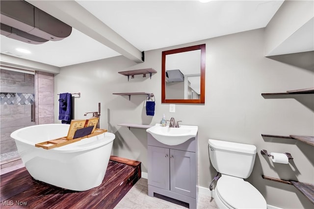 full bathroom featuring baseboards, toilet, a soaking tub, beamed ceiling, and vanity