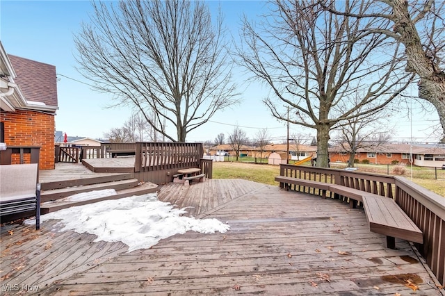 wooden deck featuring a residential view and a lawn