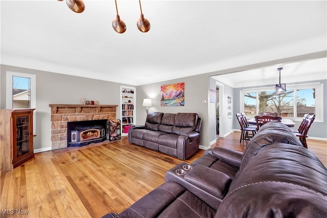 living room featuring baseboards and light wood-style floors